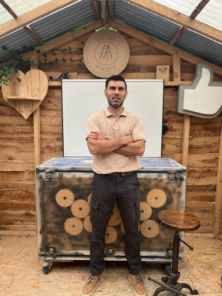 Martin Glynn from The DIY Academy, standing in front of a shelf built at a recent in-person DIY course