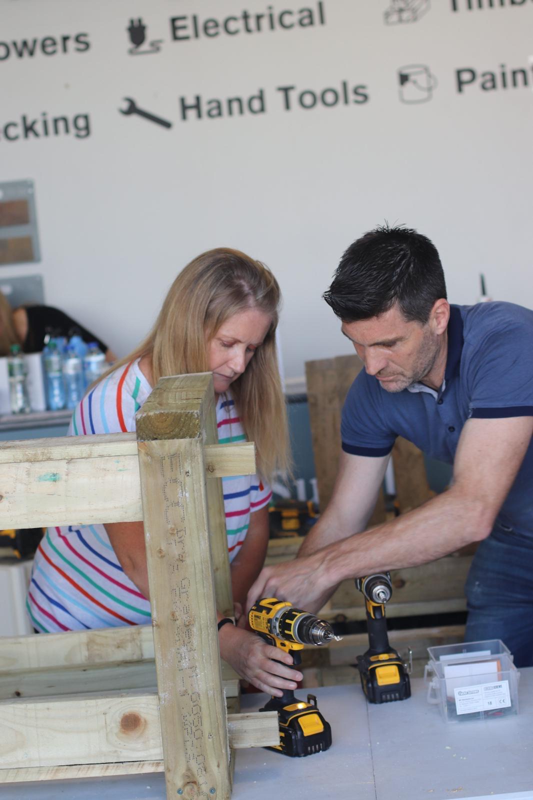 Martin Glynn from The DIY Academy, showing a participant how to use a drill at a recent in-person DIY course